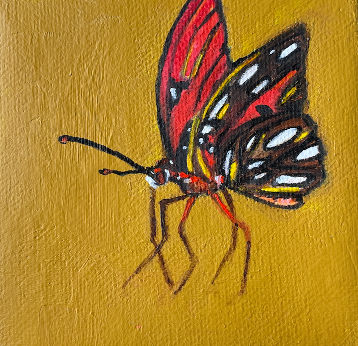 Painting of a butterfly on a gold background