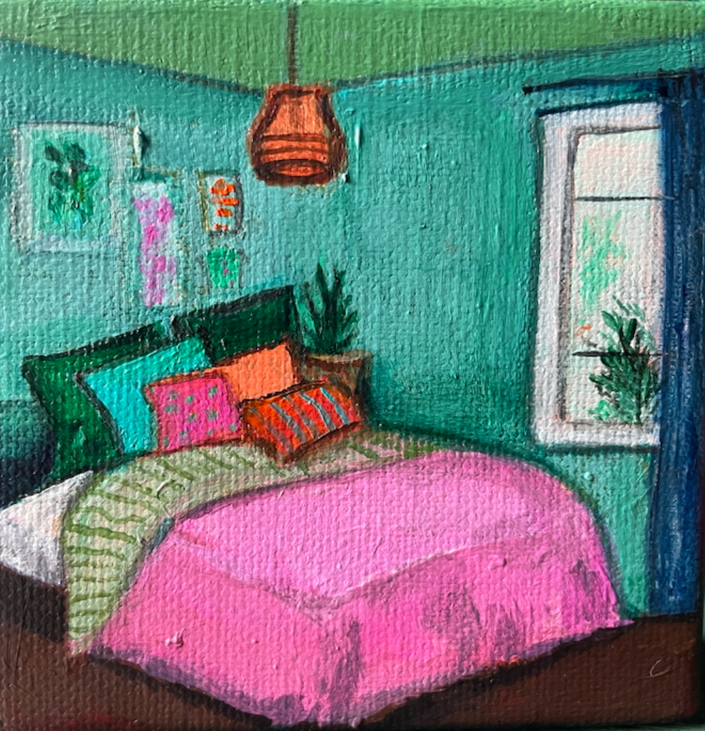 Colorful bedroom with a bed, pillows, and a window.