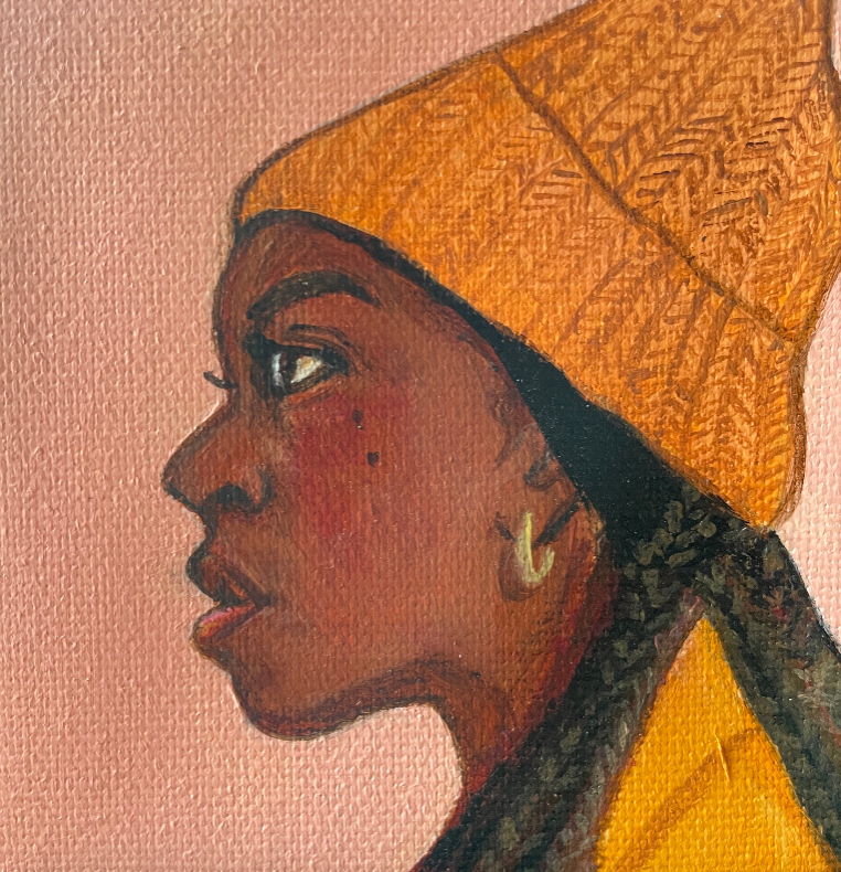 Close-up of a woman wearing a yellow woollen hat on a textured pink background