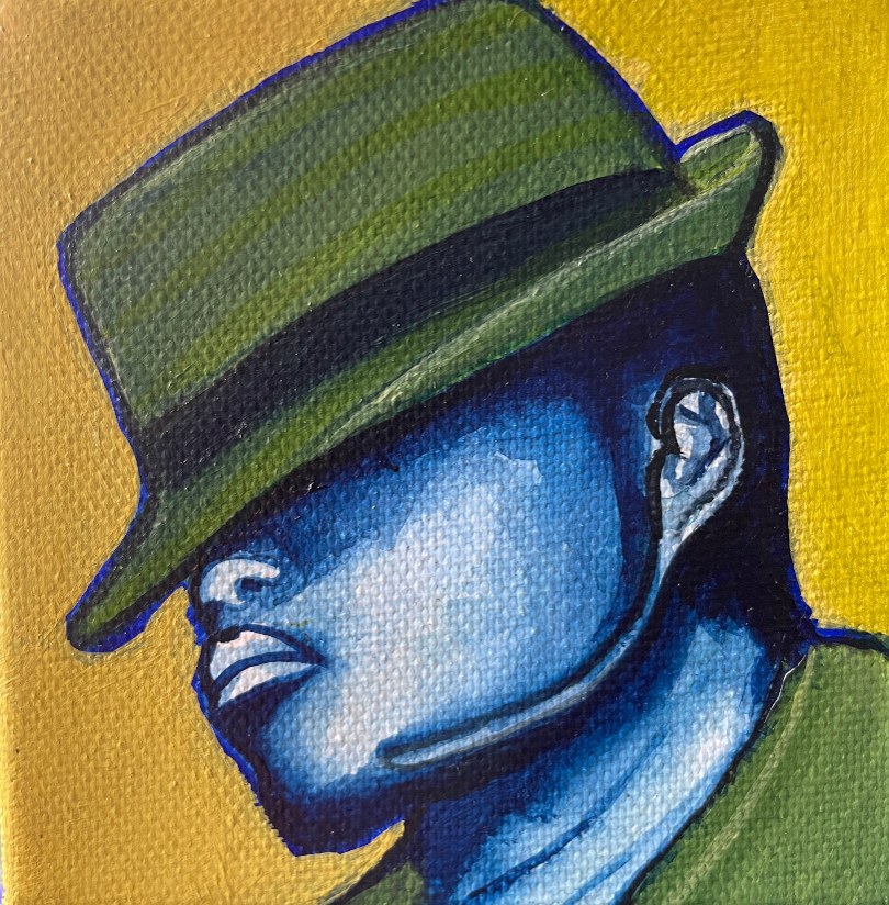 Man painted in blue wearing a green hat on a gold yellow background