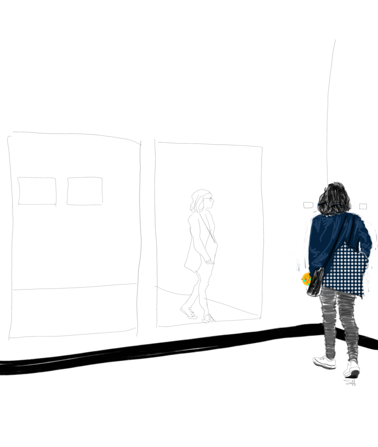 Young woman wearing blue and black walking through an art gallery