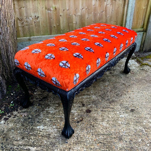 Orange velvet bench with skull design